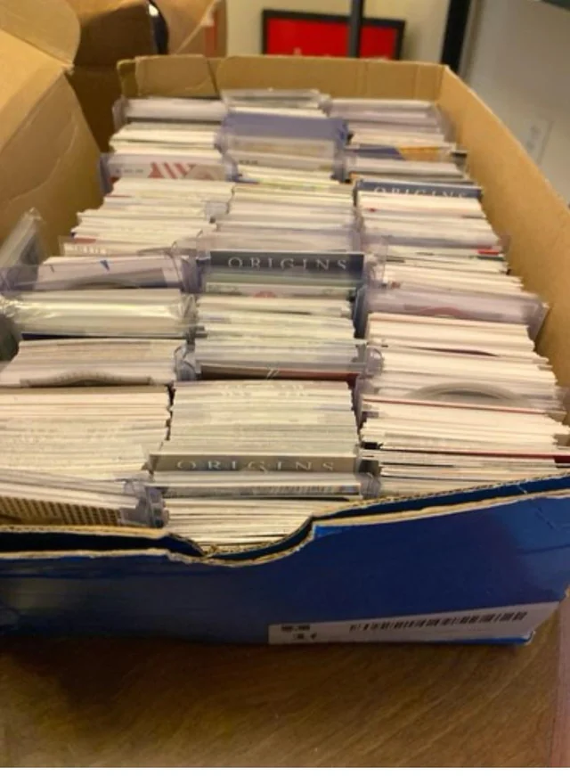A real shoebox full of collectible trading cards ready for evaluation